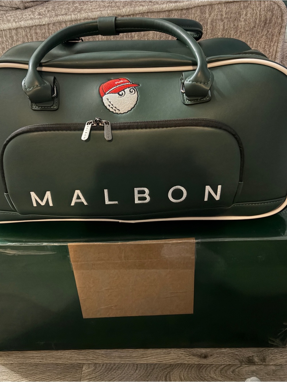 Malbon Boston Luggage bag w/ retractable handle. And separate shoe compartment.